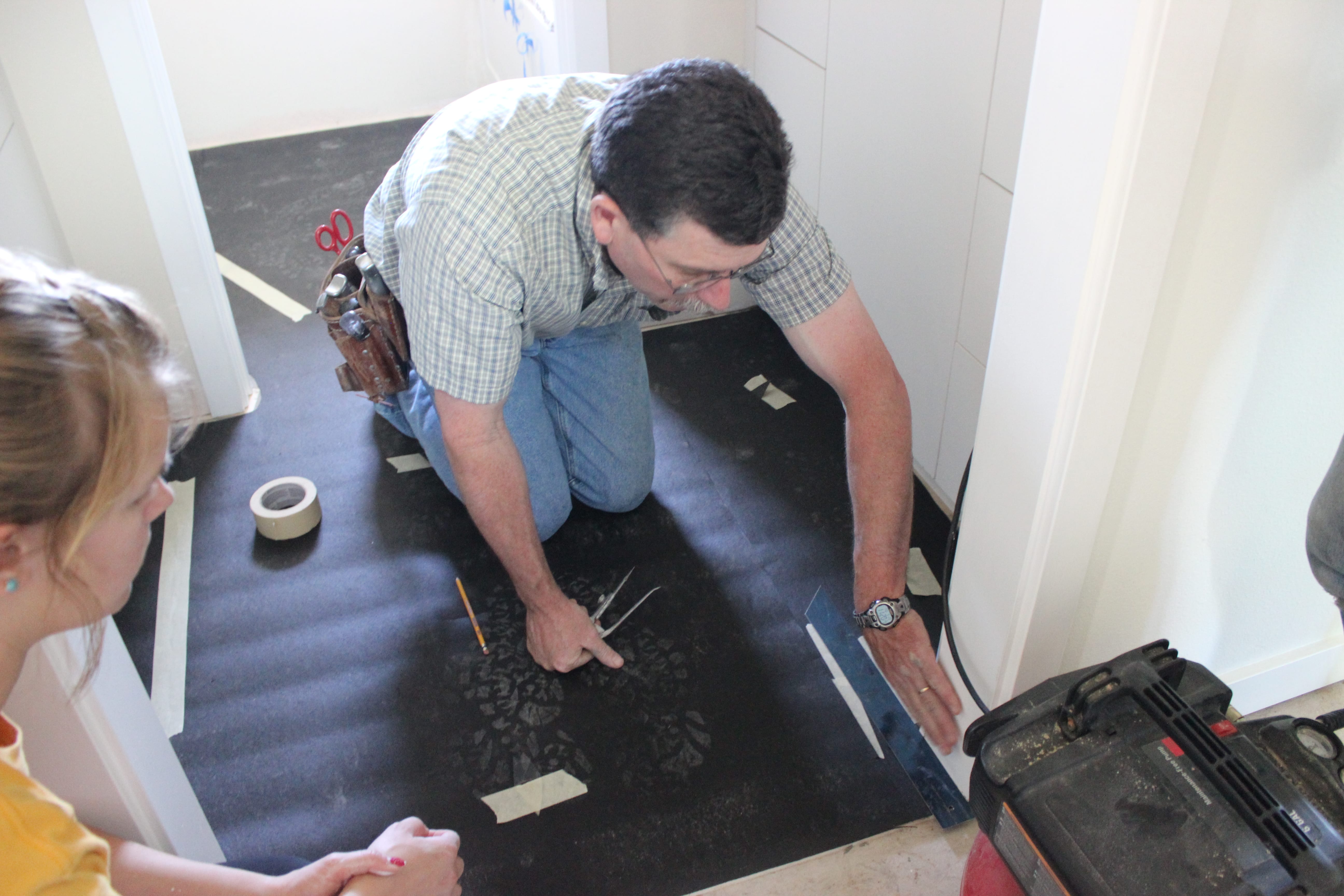 A specialist teaching us how to install linoleum