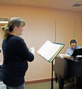 Sophomore Emilie O’Connor practices a piece with her voice teacher, Adjunct Professor of Music Mark Kano, in a Grant practice room.
