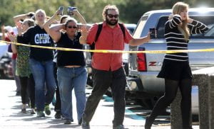 Students, staff and faculty are evacuated from Umpqua Community College in Roseburg, Ore. after a deadly shooting Thursday, Oct. 1, 2015. (Michael Sullivan /The News-Review via AP)