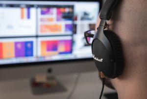 Instructor with headset on recording a screen capture.