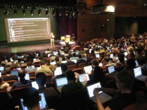 Students taking an exam in a lecture hall.