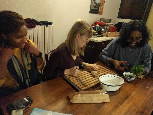 A group of people sitting at a table eating food

Description automatically generated