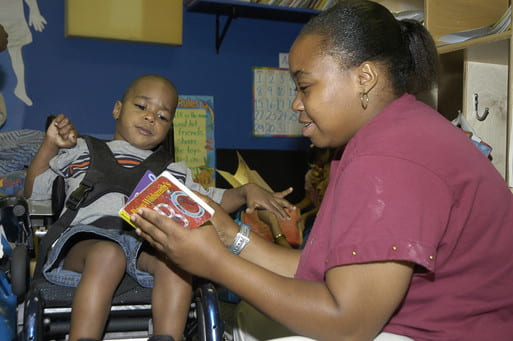 Child with disabilities listening to a book