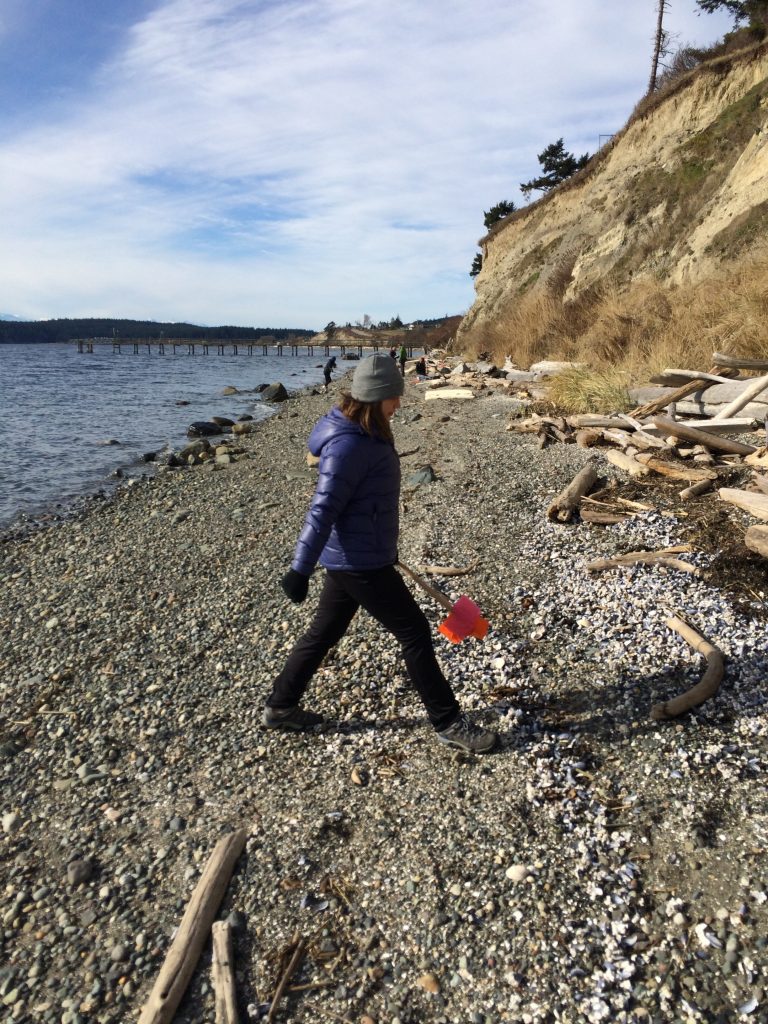 Service learning student Christie paces the width of the beach.