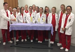 William Lambert, far left, lighted candles at the mental health vigil. Other nursing students volunteered as ushers and distributed material.