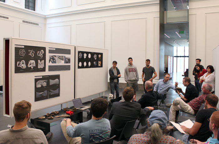 Students present the drawings and models they created during the weekend workshop.