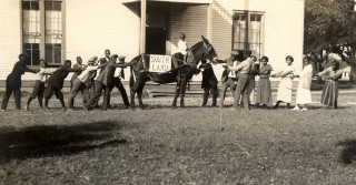 Students of Southland College having fun with their mascot, a stubborn mule, ca. 1920. From the Southland College Papers (MC577). The image is included in the exhibit "Lives Transformed" about the early Southern private school for African Americans originally founded by Quakers in Helena, Arkansas as an orphanage for refugee former slaves during the Civil War, in the Walton Reading Room in Mullins Library.