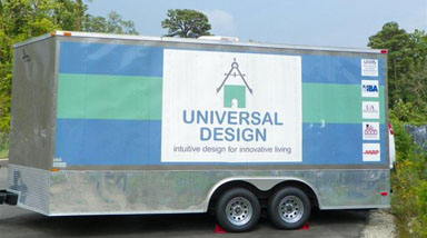 A silver trailer with a large sign that says universal design: intuitive design for innovative living