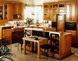 A kitchen with bar in the middle with a lower level platform that pulls out.