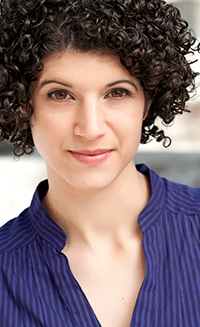 Portrait of young woman with curly black hair.