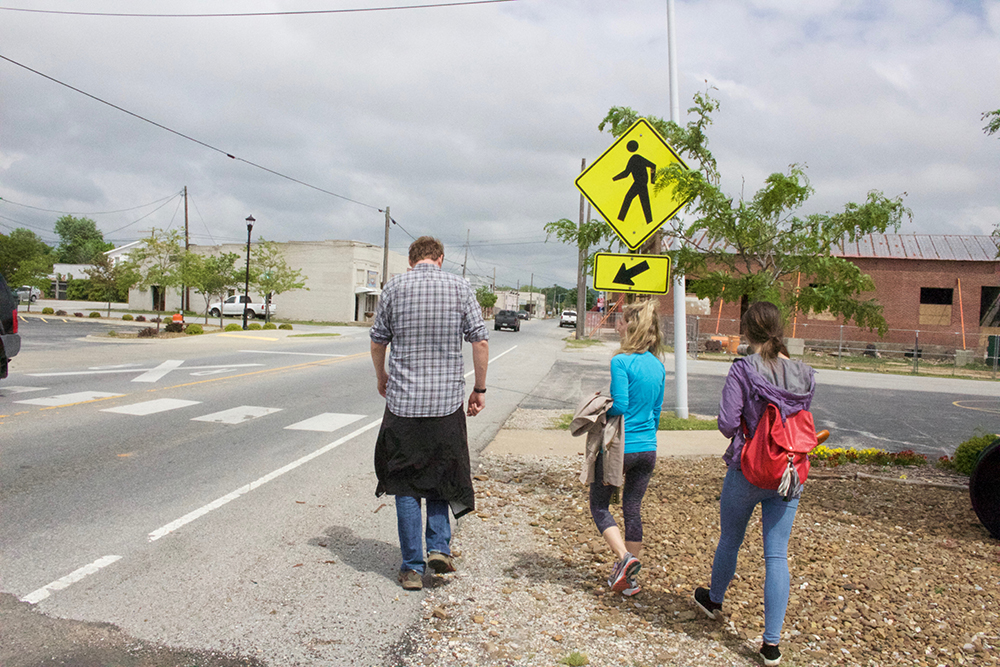 Groups crosses railroad to a more derelict area of downtown.