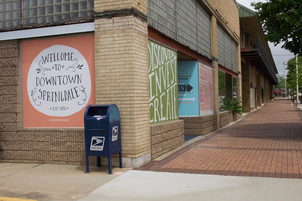 Empty downtown with "Welcome to Springdale" sign painted on building. 