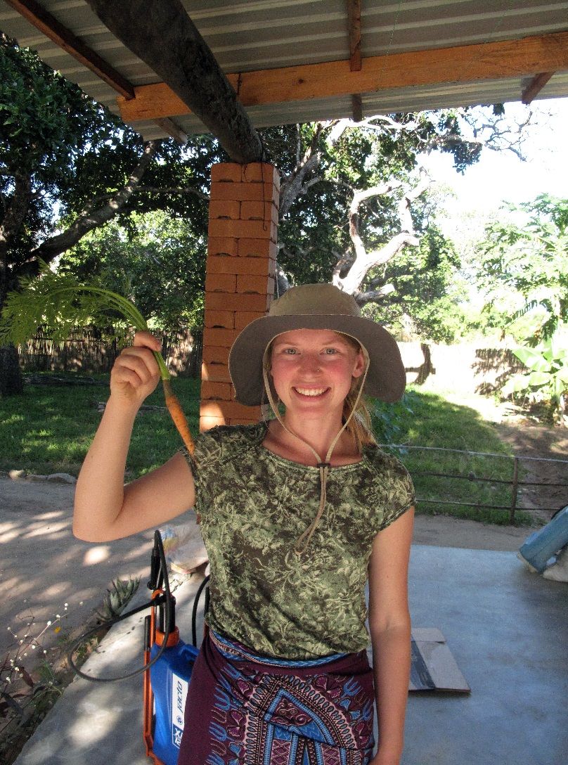 Student holds carrot.