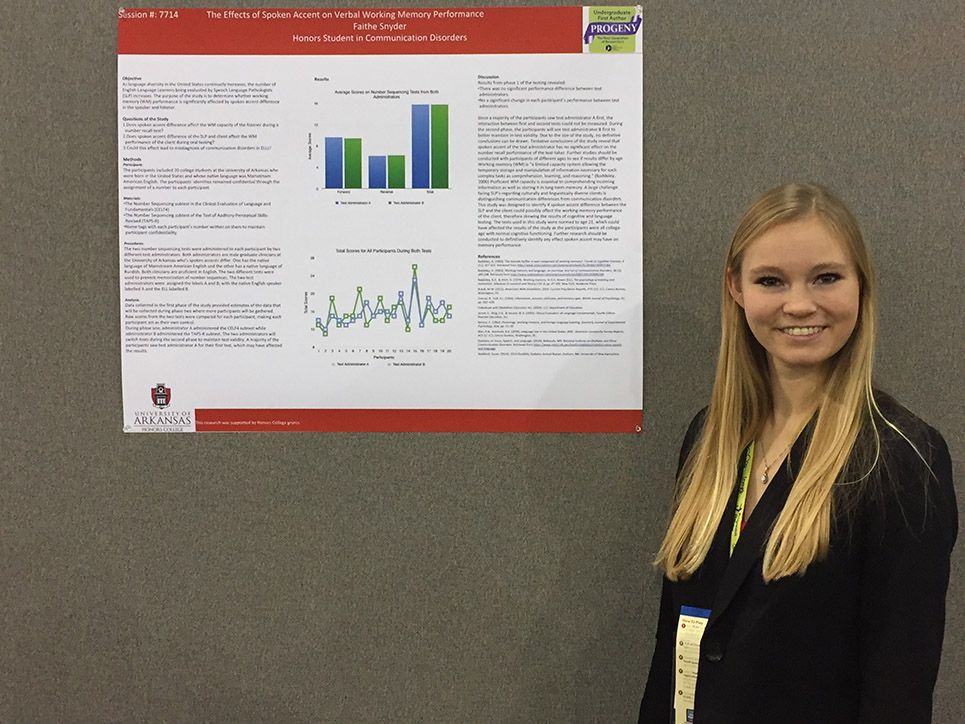 Student displays her research poster.