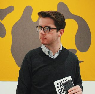 Student in front of abstract painting.