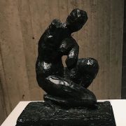 bronze sculpture of a woman kneeling.