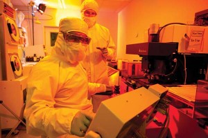 Khaja, foreground and Hutchings working in one of the University of Arkansas' class 1000 cleanrooms.