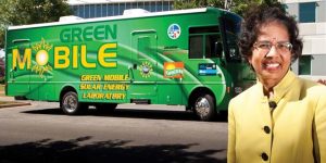 A woman posing in front of a green RV