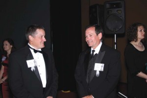 two men dressed in black tie attire