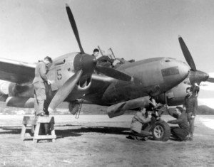 an old photo of students working on a plane