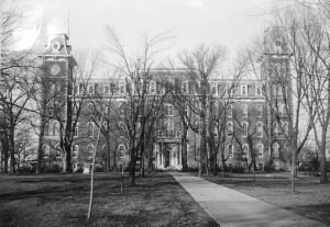 an old photo of old main, surrounded by bare trees