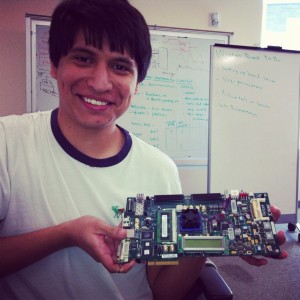 a student holding a piece of computer hardware