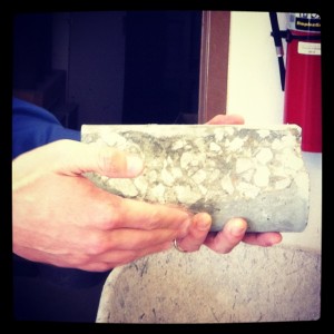 a professor holding a piece of concrete