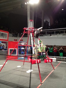 a robot climbing up a metal pyramid