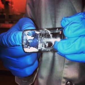 hands holding a glass jar full of a white powder