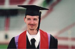 a young man in graduation regalia