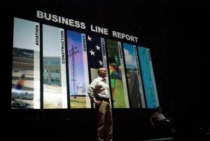 a man standing in front of several digital images