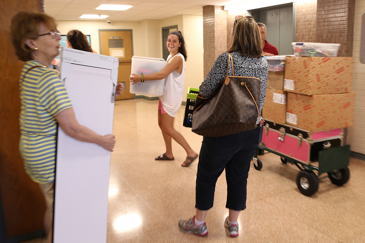 Gamma Chi volunteers and parents wait in the Yocum ground floor elevator lobby.