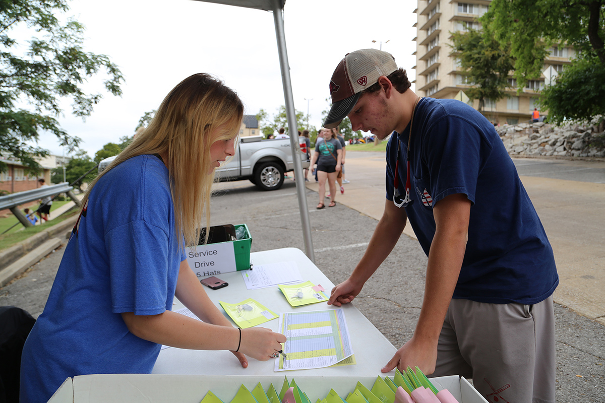 Caitlyn Tucker, Walton RA, checks a student into Gladson-Ripley.