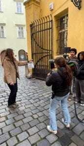 Students stand readily in the streets to begin a scene by watching the clapperboard, telling them that they can begin