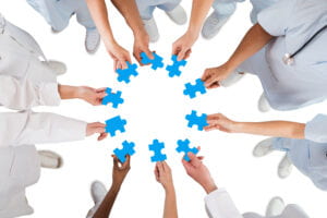 health providers holding puzzle pieces