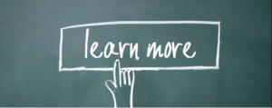 Blackboard with finger pointing to text reading "learn more"