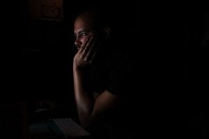 Man staring at computer in the dark