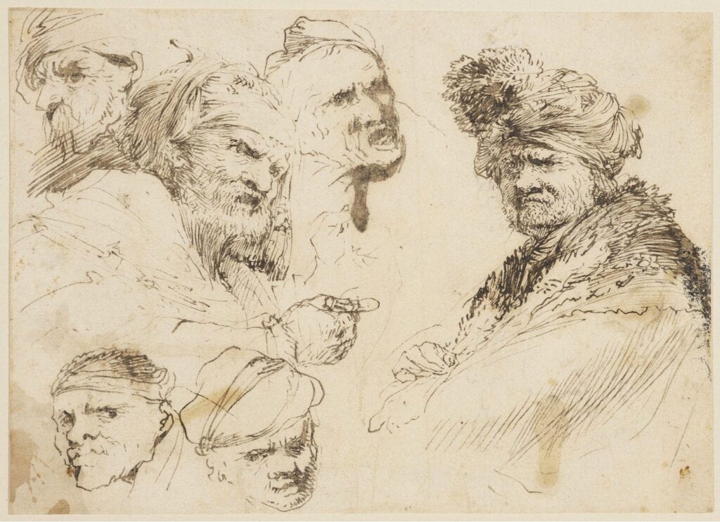 Drawing with multiple male heads on the page.