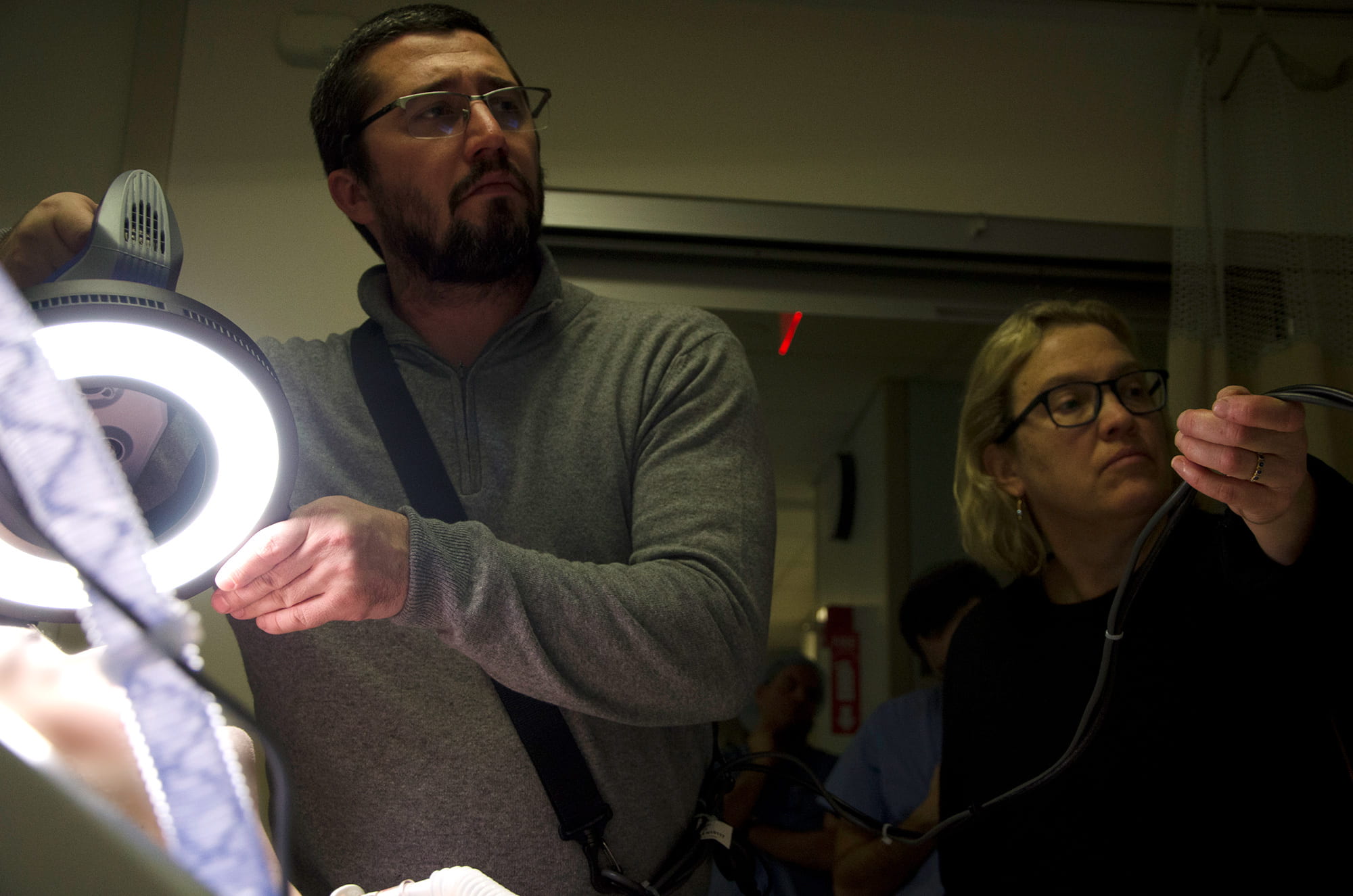 two people in a hospital room performing a 3D scan