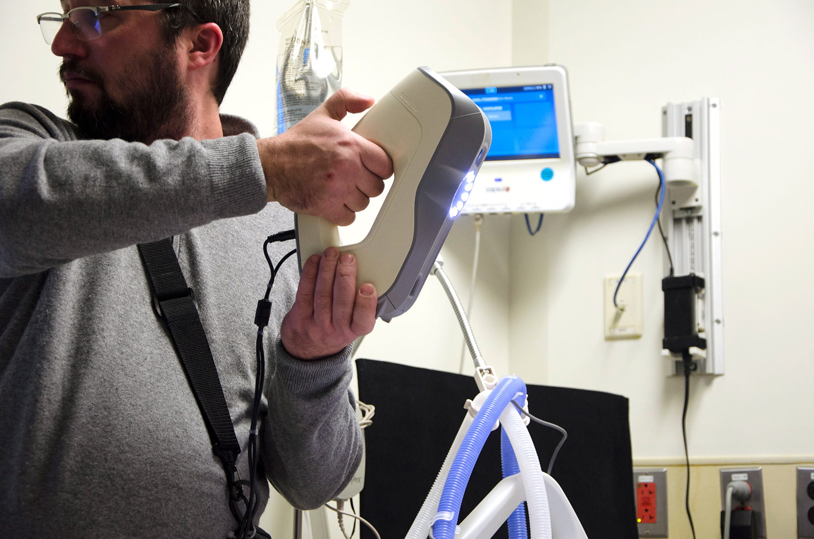 man holding a 3D scanning device