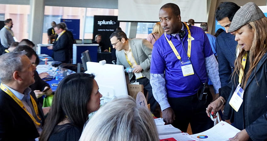 attendees at a vendor table at the NYU Technology Summit