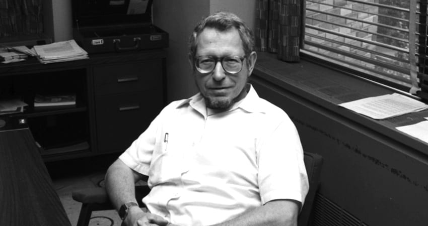 George Sadowsky sitting behind a desk in an office