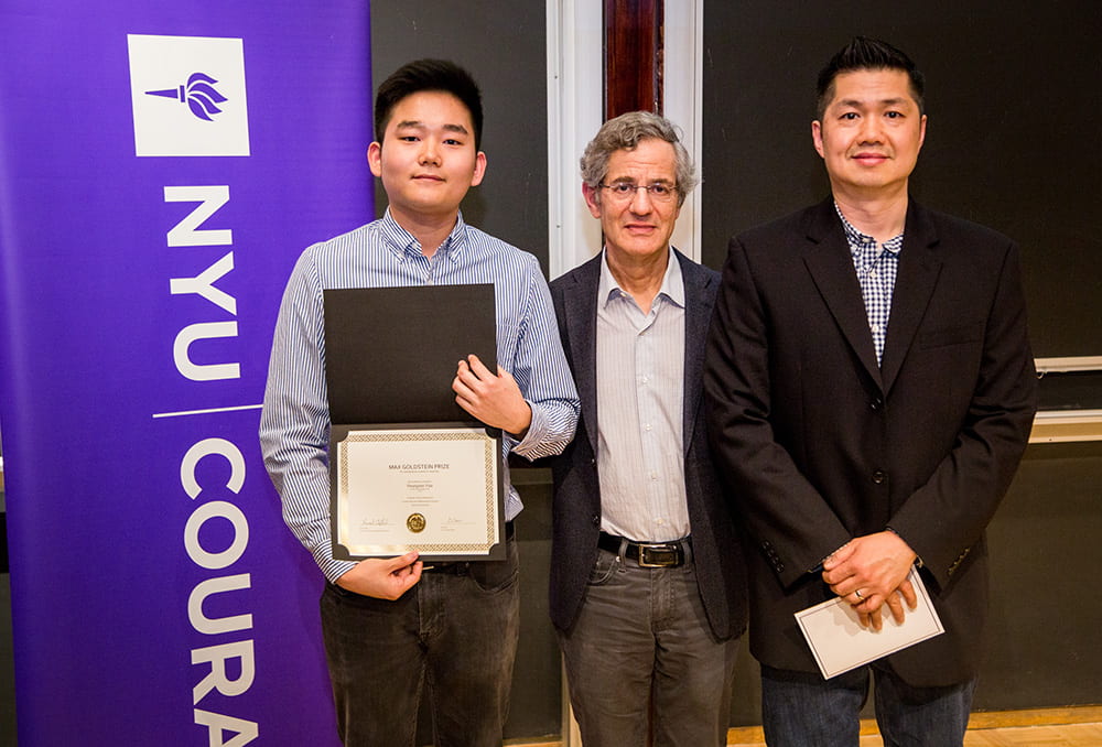 Daniel Woo holding his award