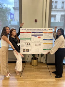 Three researchers presenting their poster titled "Mutual Exclusivity in Sounds and Verbs"