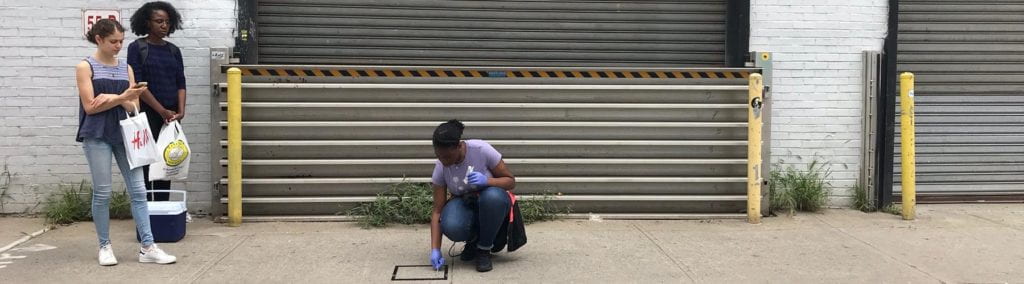 3 people swabbing the sidewalk.