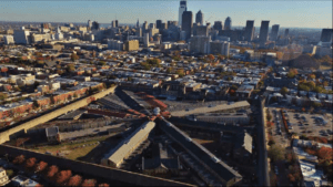 Overhead view of penitentiary with skyline of Philadelphia in the background.