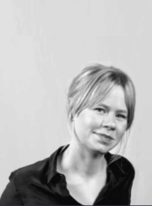 Black and white portrait of Lauren Race on a white background, wearing a black collared shirt.