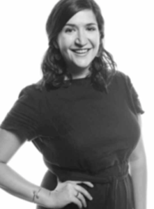 Black and white portrait of Sara Lowenburg on a white background, wearing a black dress.