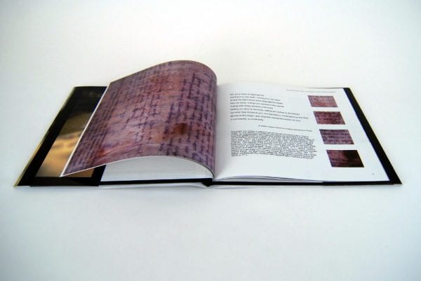 Image of a book opened to a visual image and text