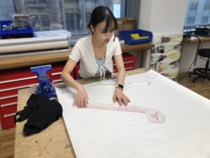 Image of Ploy drawing the pattern for the vest prototype